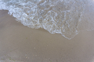 Beach close-up: sand and waves
