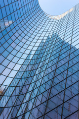 Blue glass skyscraper facade reflections against sky - 281942288