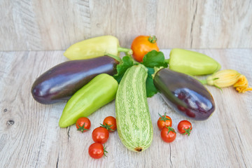 close up of freshly pickled harvest of vegetbles - bell pepper, drill and tomatoes on wooden table. Rustic style. Organic healthy food concept with copy space
