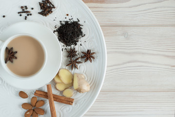 Traditional indian masala tea with spices in a white Cup