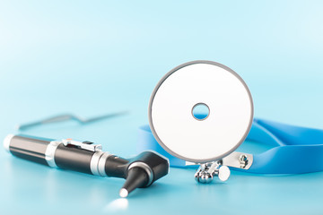 Ear professional instrument on blue background.