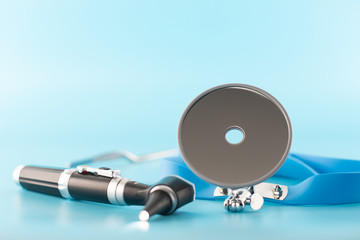 Ear professional instrument on blue background.