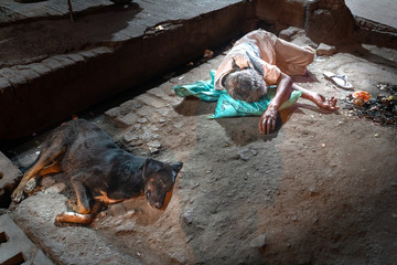 The homeless man sleeping on the street with dog