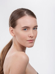 Young girl's face without makeup on white isolated background