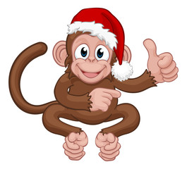 A Christmas monkey animal cartoon character in a Santa hat giving thumbs up and pointing