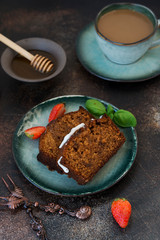 Two pieces of delicious honey cake with a Cup of coffee on a dark concrete background. Vertical orientation