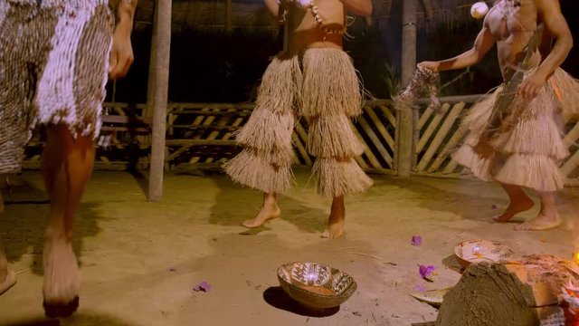 Traditional Indigenous Ceremony In The Jungle By Night With Mans Jumping And Dancing Around The Fire In Ecuador