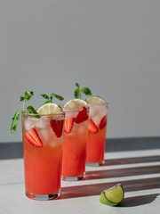strawberry lemonade in glasses on a gray background