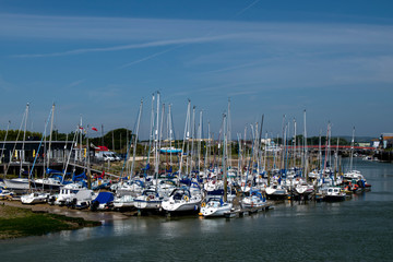 Yachts moored river arun littlehampton on the west bank outside the yacht club, on a sunny warm summers day in England in July.