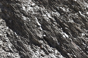 Texture of grey natural slate stone found in the alps of switzerland.
