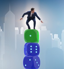 Businessman balancing on top of dice stack in uncertainty concep
