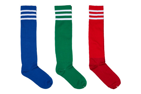 three pairs of colored football leggings or socks, in an upright position, on a white background