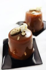Coffee and chocolate dessert with popcorn and golden almond