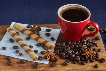 cup of coffee on the board with dessert and coffee beans in natural light