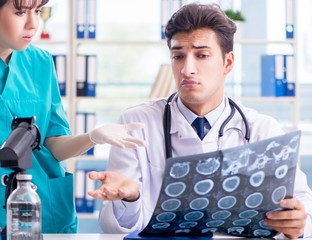 Two doctors discussing x-ray MRI image in hospital