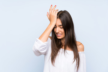 Young woman over isolated blue background having doubts with confuse face expression