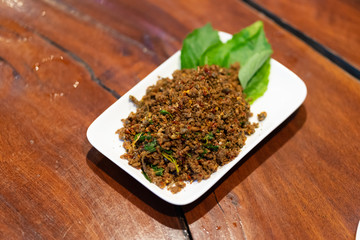 Close up Fried Spicy Frog with herb on white plate is thai food and thailand