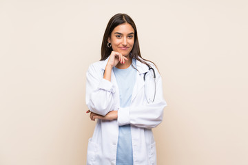 Young doctor woman over isolated background laughing