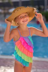 Portrait of fashion child in swimming pool. Summer vacation concept