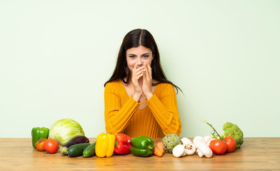 Teenager girl with many vegetables scheming something