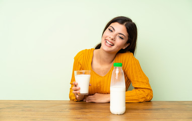 Happy Teenager girl having breakfast milk