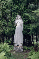 woman statue in green woods at Rottneros park garden, Sweden