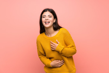 Fototapeta premium Teenager girl over isolated pink wall smiling a lot