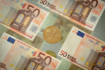 European money, banknotes 50 euro and virtual currency bitcoin