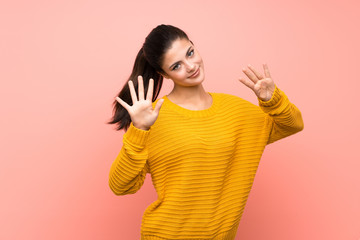 Teenager girl  over isolated pink wall counting nine with fingers