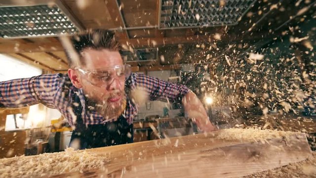 Wood chippings are getting blown away by the carpenter