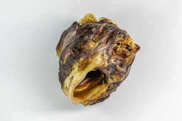 Dried beef larynx on a white background. Soft focus. Horizontal version of the picture.