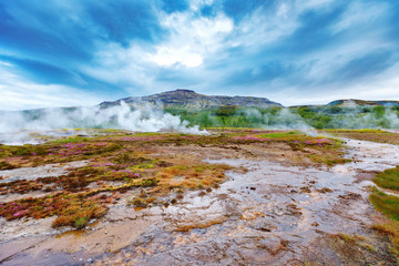 Geothermal fields Hverir. Spectacular landscape of volcanic terrain with geothermal activity in Iceland, nearby famous Hot Spring Gaysir and Strokkur, Golden Circle tourist itinerary. 