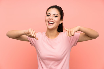 Teenager girl over isolated pink background proud and self-satisfied