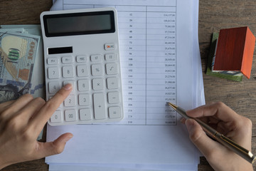 Customers use pens and calculators to calculate home purchase loans according to loan documents...