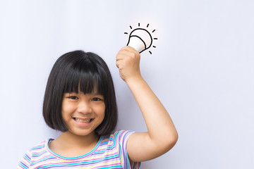 Smart asia kid hold LED bulb in her hand. Happy smiley asian girl child having an Idea concept on white background.Positive Thinking. Universal Children's Day.World Thinking Day