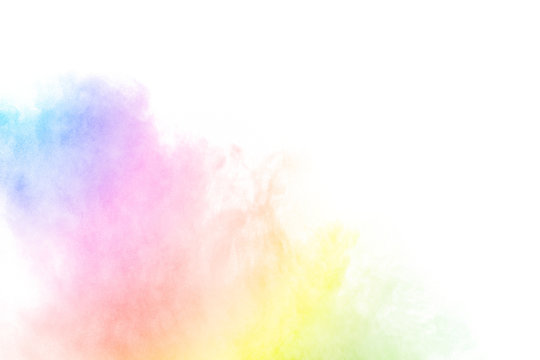 The explosion of multi colored powder. Beautiful rainbow color powder fly away. The cloud of glowing color powder on white background
