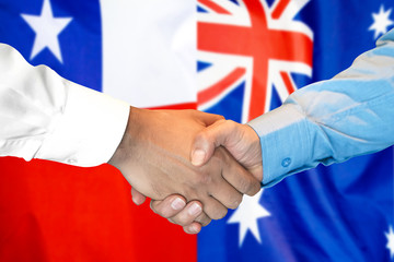 Business handshake on the background of two flags. Men handshake on the background of the Chile and Australia flag. Support concept