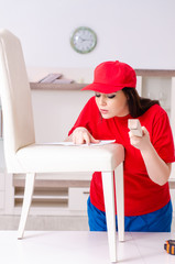 Young woman repairing chair at home