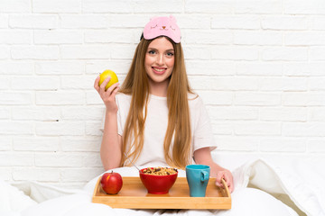 Young woman in dressing gown in bed