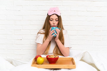 Young woman in dressing gown in bed