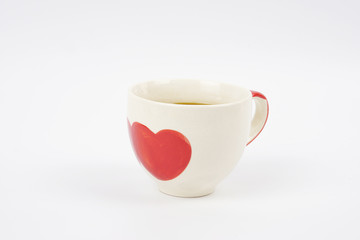 Red heart shaped coffee mug on white background