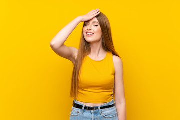 Young woman over isolated yellow background laughing