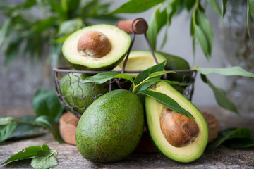 Fresh green avocado on wooden background. Selective focus. Horizontal orientation.