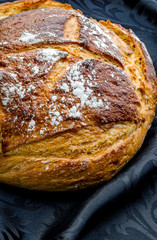 A loaf of sourdough bread freshly baked ready to be sliced and eaten.