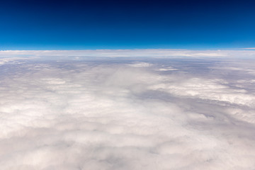 Fototapeta na wymiar Skyline View above the Clouds from airplane