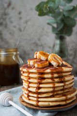 American  pancakes with banana and  caramel. Vertical orientation