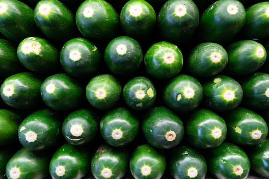 Cucumbers in a stack in produce section of grocery store