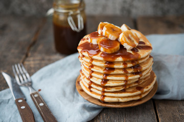 American pancakes with banana and caramel. Vertical orientation