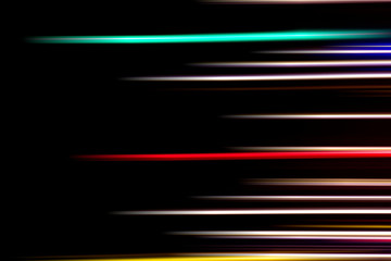 Horizontal multicolor light rays on a black background.