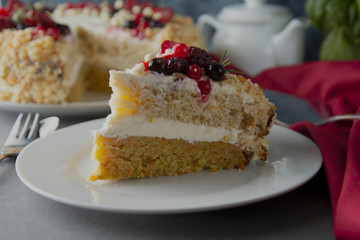 Vegan delicious carrot and orange cake decorated with berries. Healthy dessert. Grey background. Piece of cake.